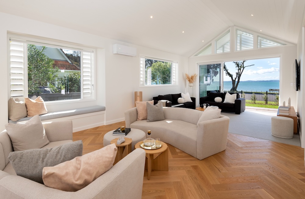 Dining area with natural light in architectural home by Metro Homes Auckland